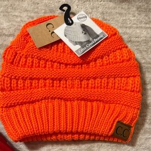 C.C Bright Orange Criss-Cross Beanie. An opening allowance for your ponytail